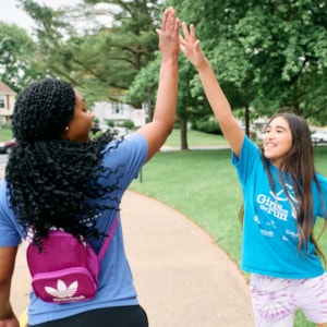 Girls on the Run coach and girl high-fiving